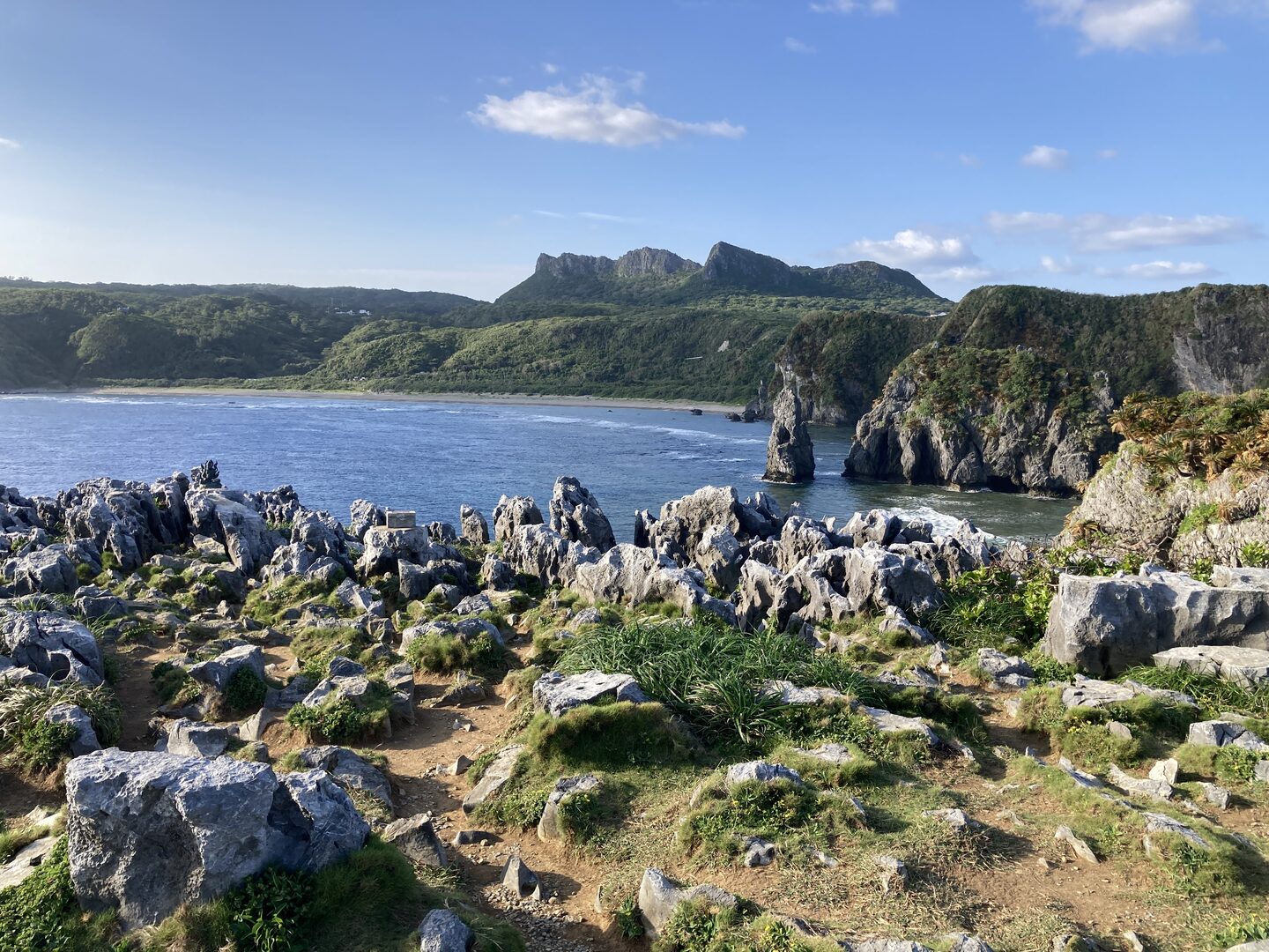 Daisekirinzan mountain seen from Cape Hedo with rock formations and bay in the foreground.
