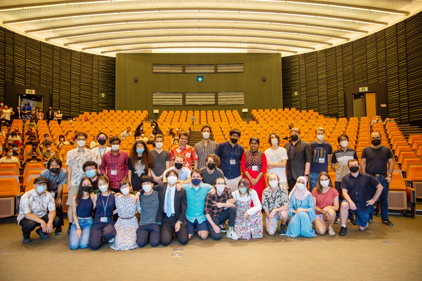 New OIST students posing for photo in auditorium